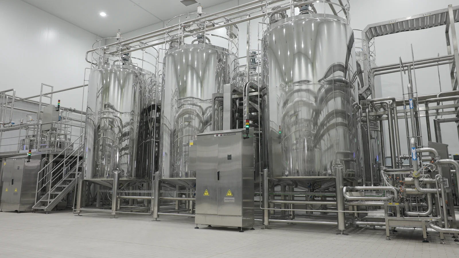 Stainless-steel tanks, stairs and pipework inside the supplied factory footage
